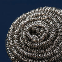 Close-up van de gedraaide metalen spiraal van een titanium pannenspons